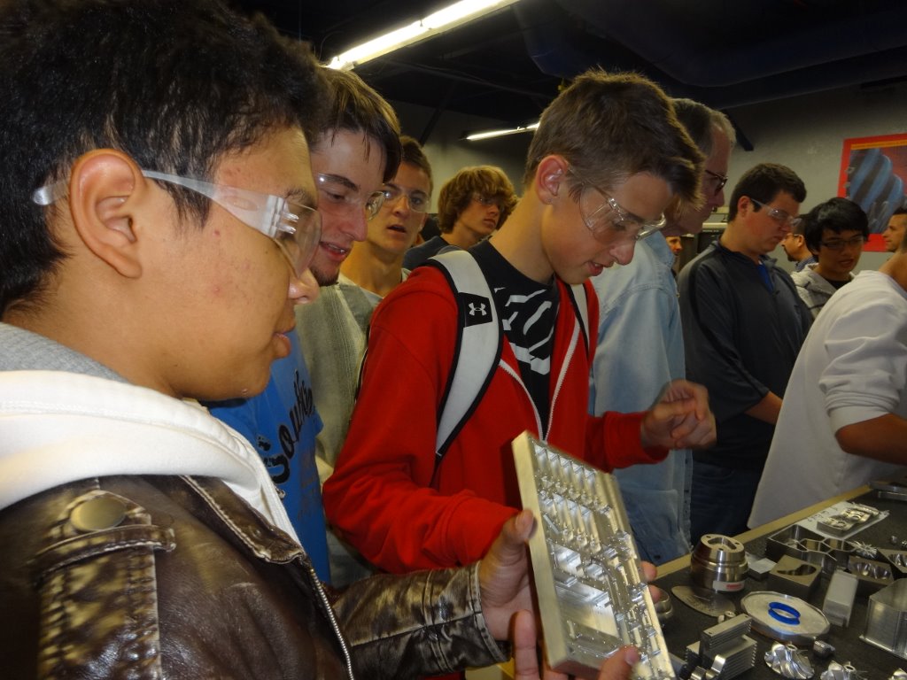 Rocklin High School students look at products made with RobbJack cutting tools during a Manufacturing Day tour.