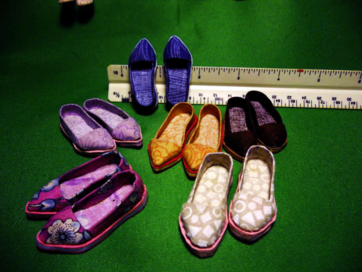 Image 13: Here are shoes made mostly of fabric and polymer clay. They are very small pieces that are about 1 1/4 inches in length. It's funny how small they can be