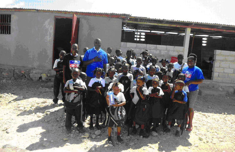 Another picture of Father Lucien with students and teachers from the school.