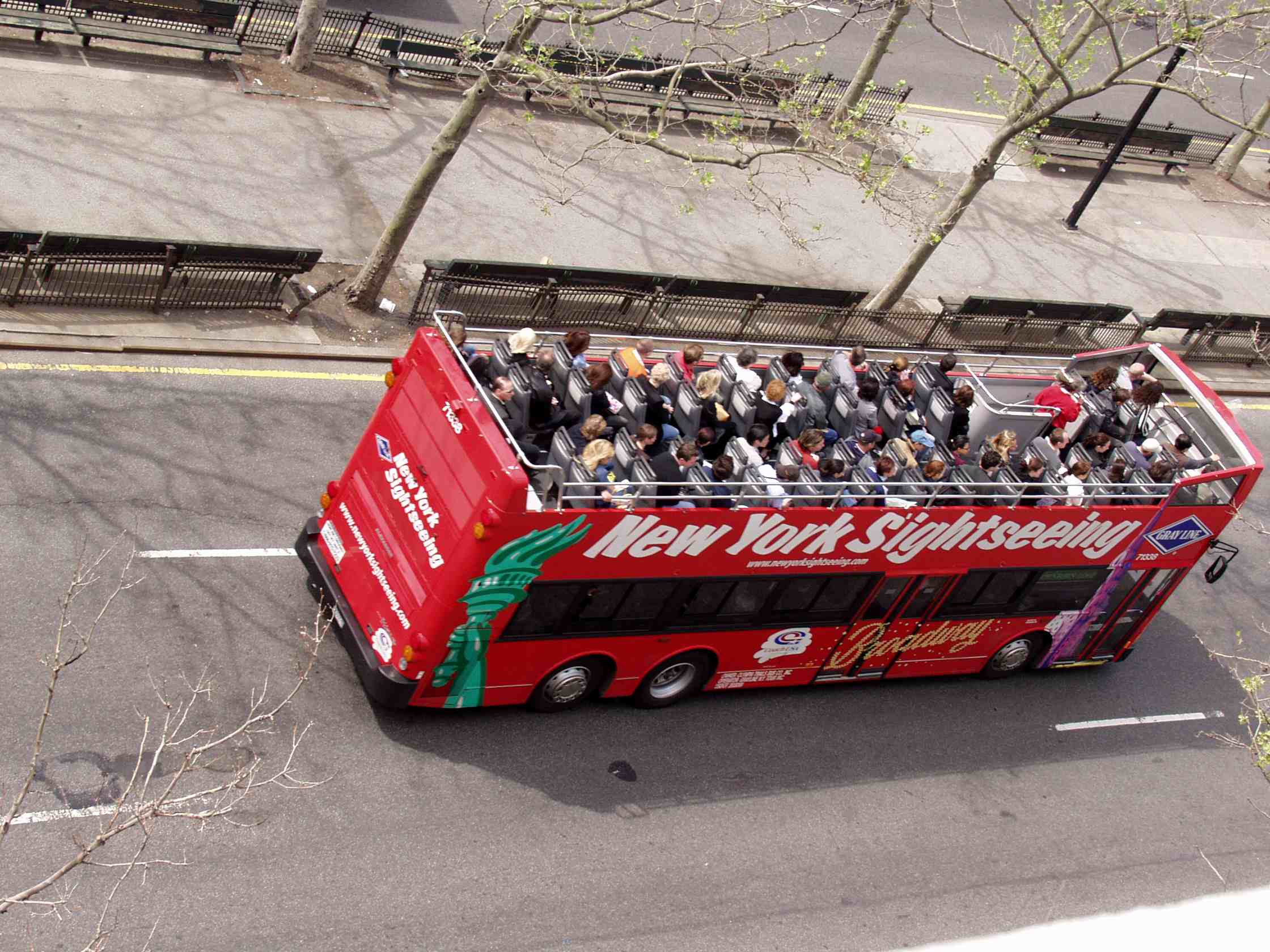 New York City double-decker sightseeing buses are popular with tourists.