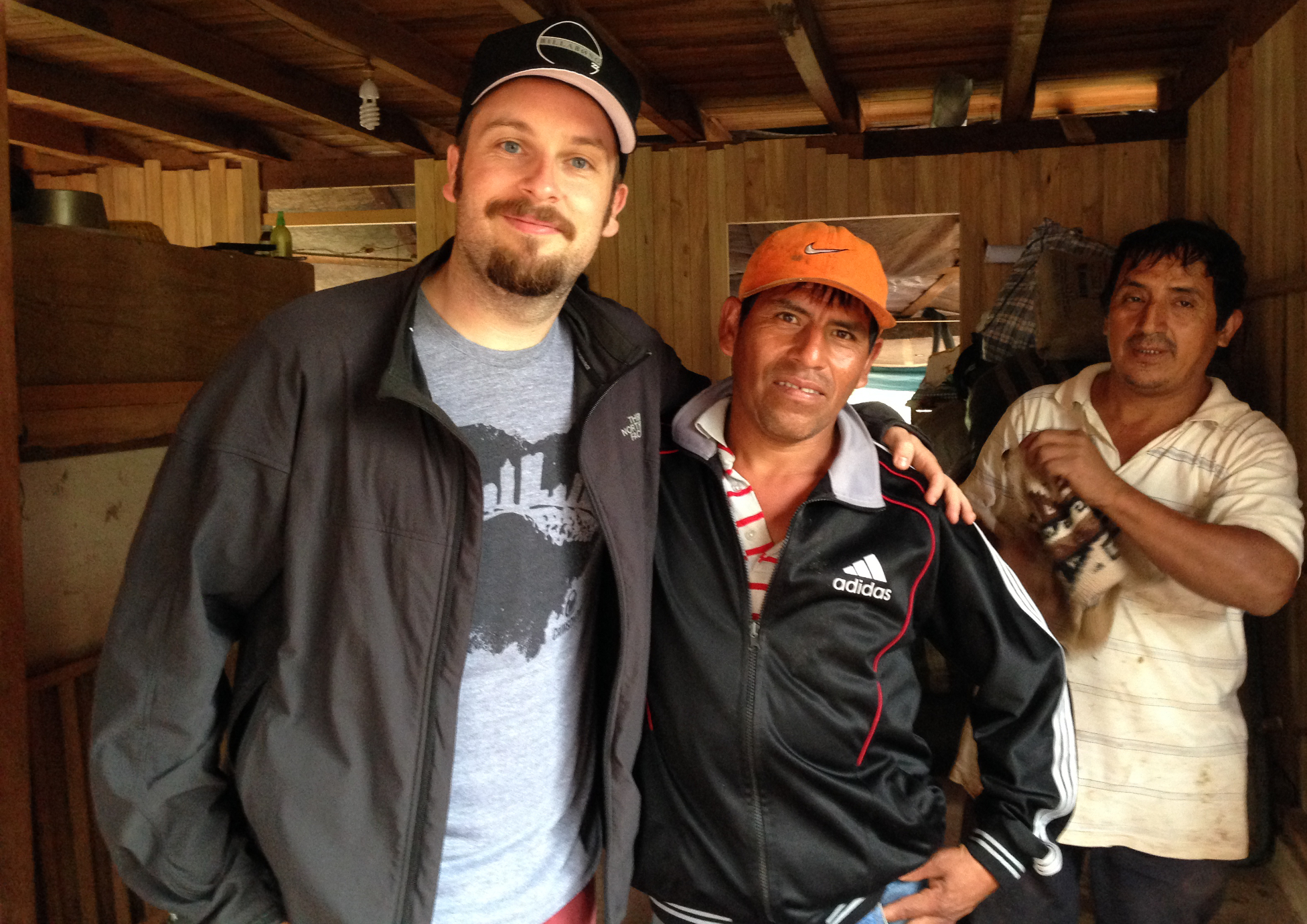 Brandon Bir (left) of Crimson Cup Coffee & Tea meets with coffee farmers in Peru