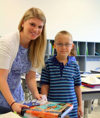 Mrs. Johnson shows her student the books they will be using this coming school year.