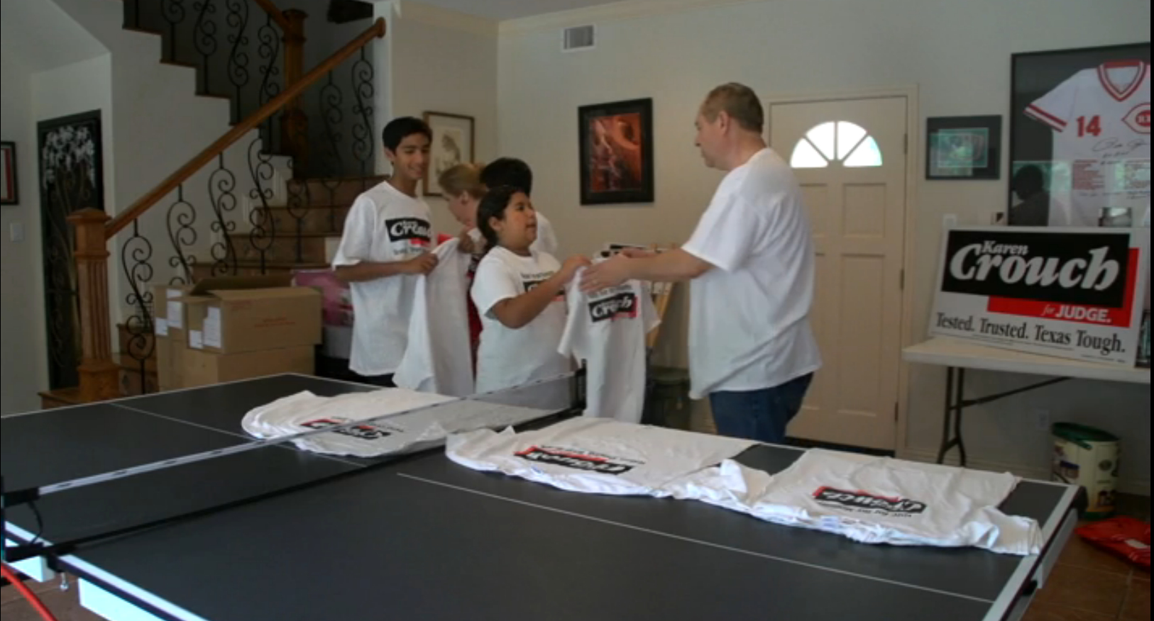 Karen Crouch, her husband Gerald Flores and their children, Gerald, Nicholas and Lillianna pitch in to sort campaign t-shirts.