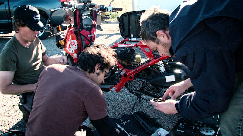 Roadside surgery on the 50cc Ruckus. Left to right, Brendan, Oz and Aaron.