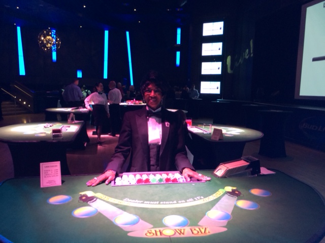 Blackjack table with dealer and pin spot lighting