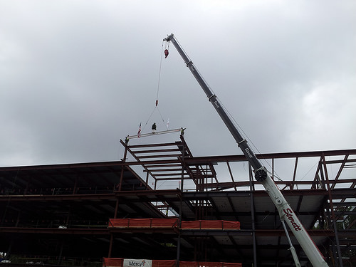 The final beam of the world's first virtual care center is hoisted into place.