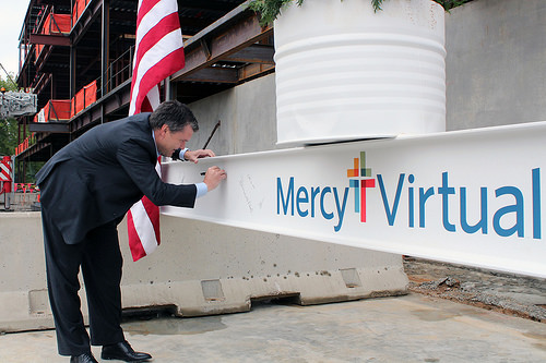 Mercy's Shannon Sock, executive vice president and chief financial officer, signs the final beam "To the Future."