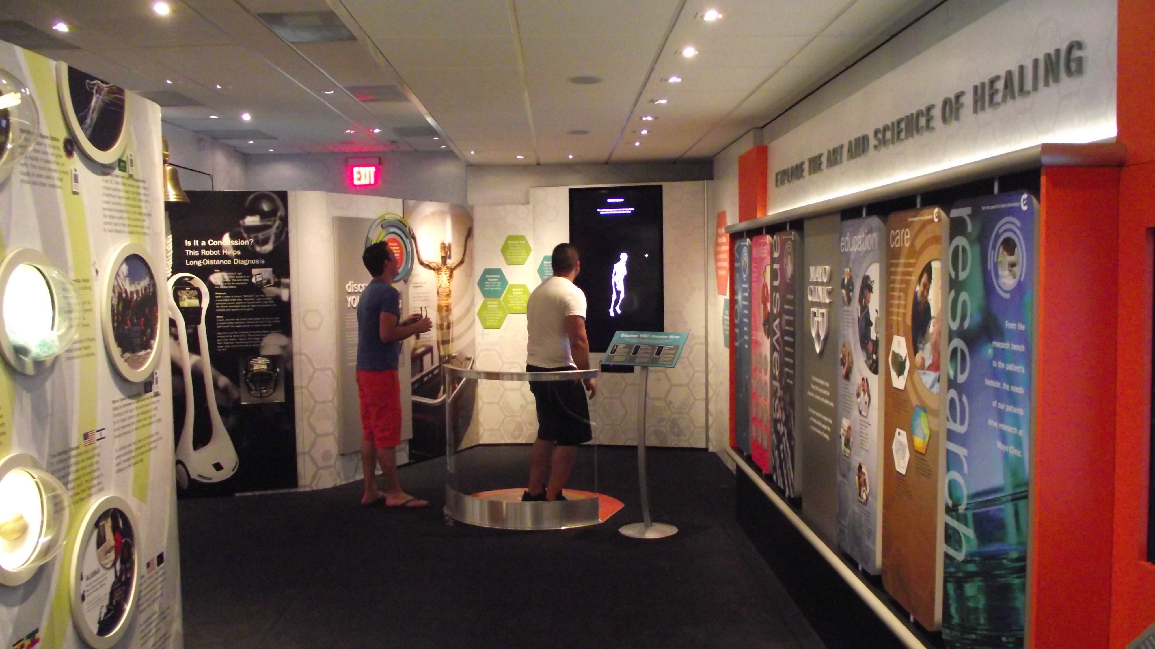 Visitors to the Mayo Clinic tour engage with one of several multimedia elements within the exhibit.