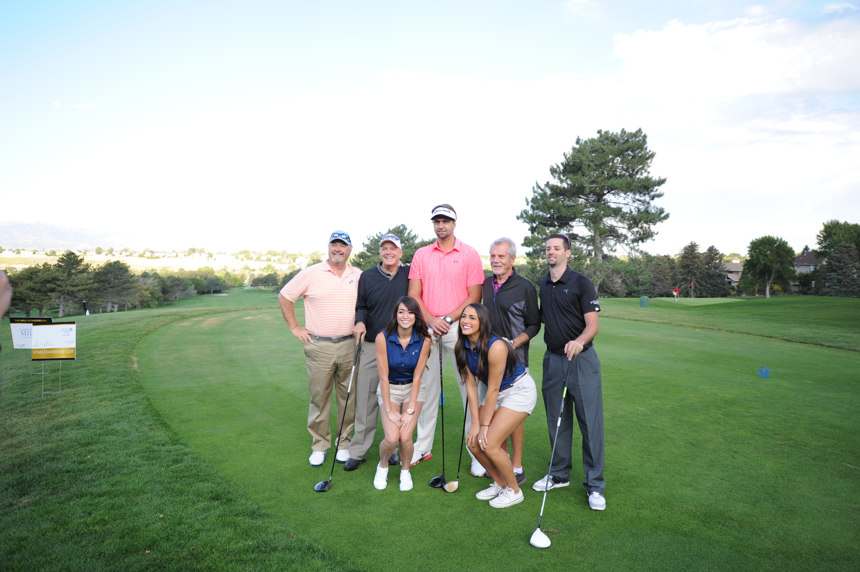 Former Utah Jazz player Mehmet Okur and two Utah Jazz Dancers pose on the first tee with a team of golfers.