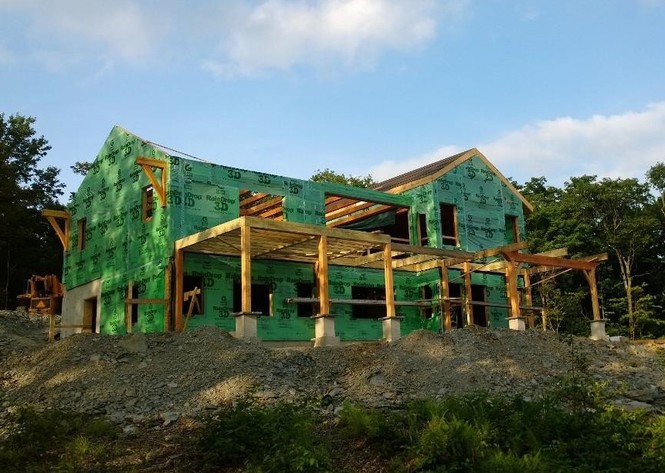 Progress continues on the Olsen home as New Energy Works construction team nears completion of the 2x6 Matrix Wall enclosure and framing of the screened porches.