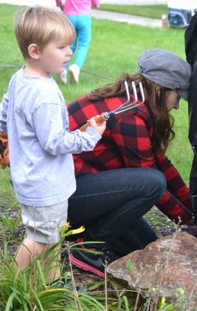 Working by Mom's side, a young Everest student learns what yard work is all about