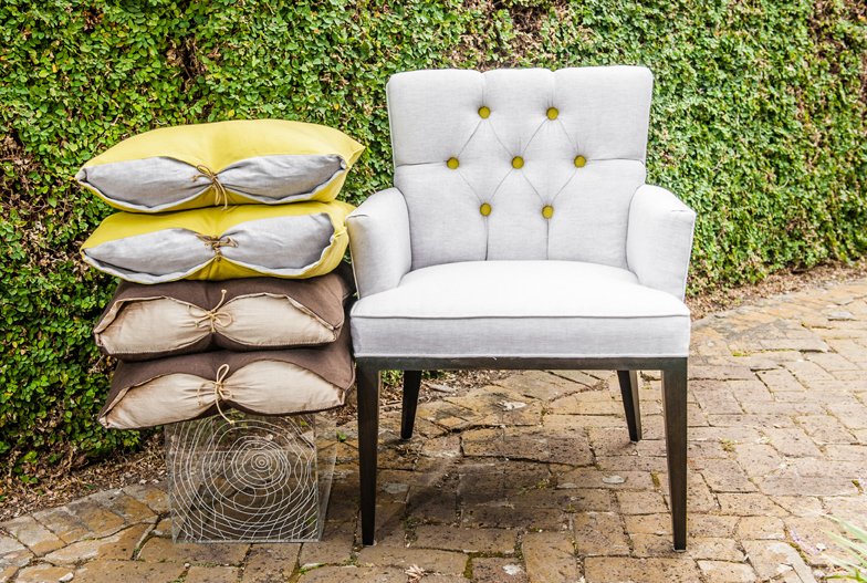 The Iberia Parish line currently includes chairs, ottomans, cord covers, candles and pillows. Photo by Geovanni Velasquez of Black and Geauxld Photography.