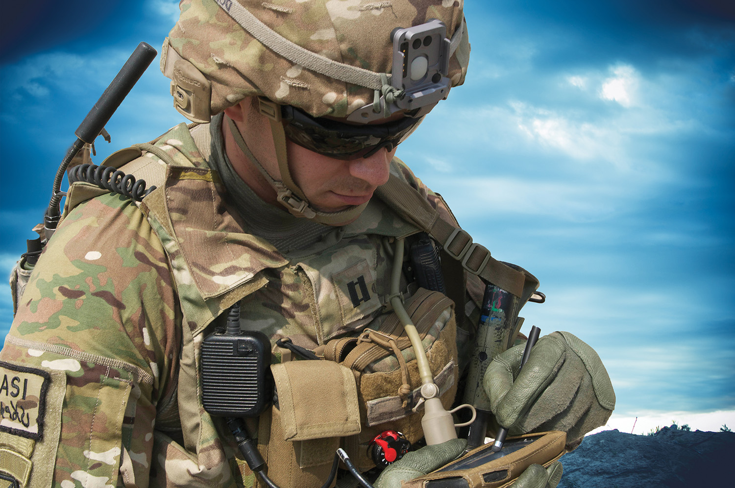 Soldier in the field using multiple electronic devices that require power.