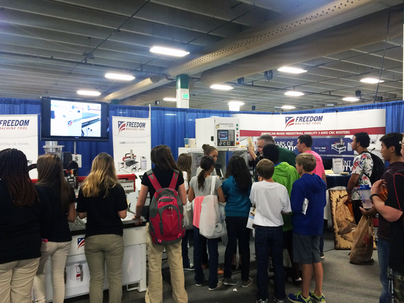 Students at the DMS CNC Routers Booth at the SOCOM Expo 2014