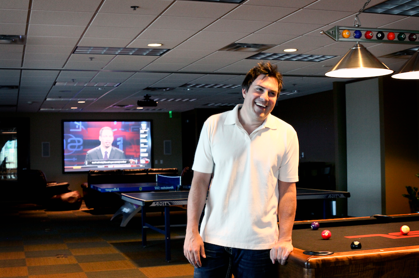 Jason Hope leaning on pool table