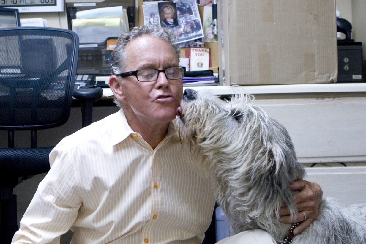 Dr. Gary Johnson gets a kiss from a very happy patient at Dana Niguel Veterinary Hospital.
