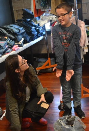 Helping hands make a joyful heart for Adrian, a 3rd grader at Everest Academy, and his mom, Kelly.