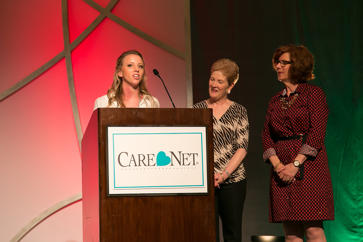 Christina Oien accepts 4 year Scholarship to Regent University, while Diane Fiazza (Regent) and Cynthia Hopkins (Care Net) look on