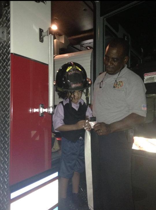Fireman Tracey lets Timmy wear his hat