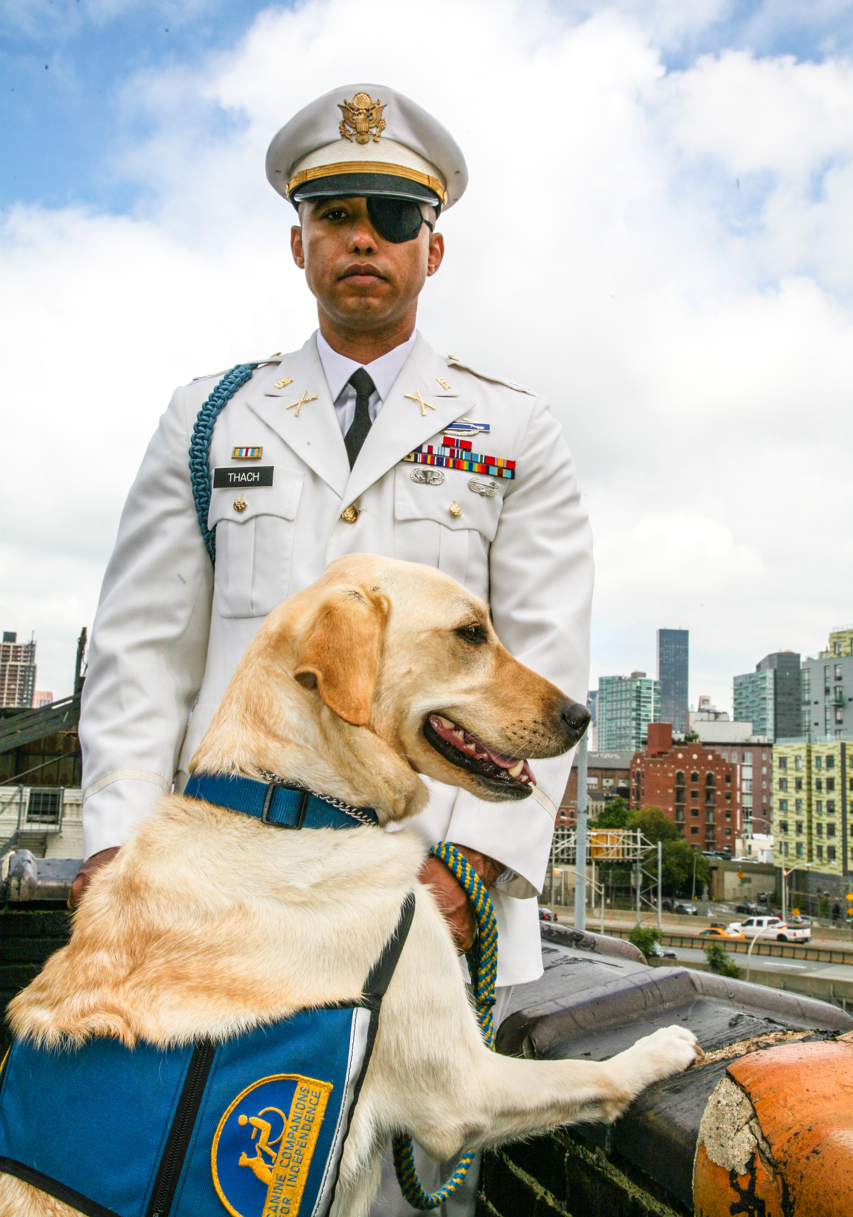U.S. Army Captain James Văn Thạch with his service dog Liz. Photo credit: Photographer Leanne Vorrias