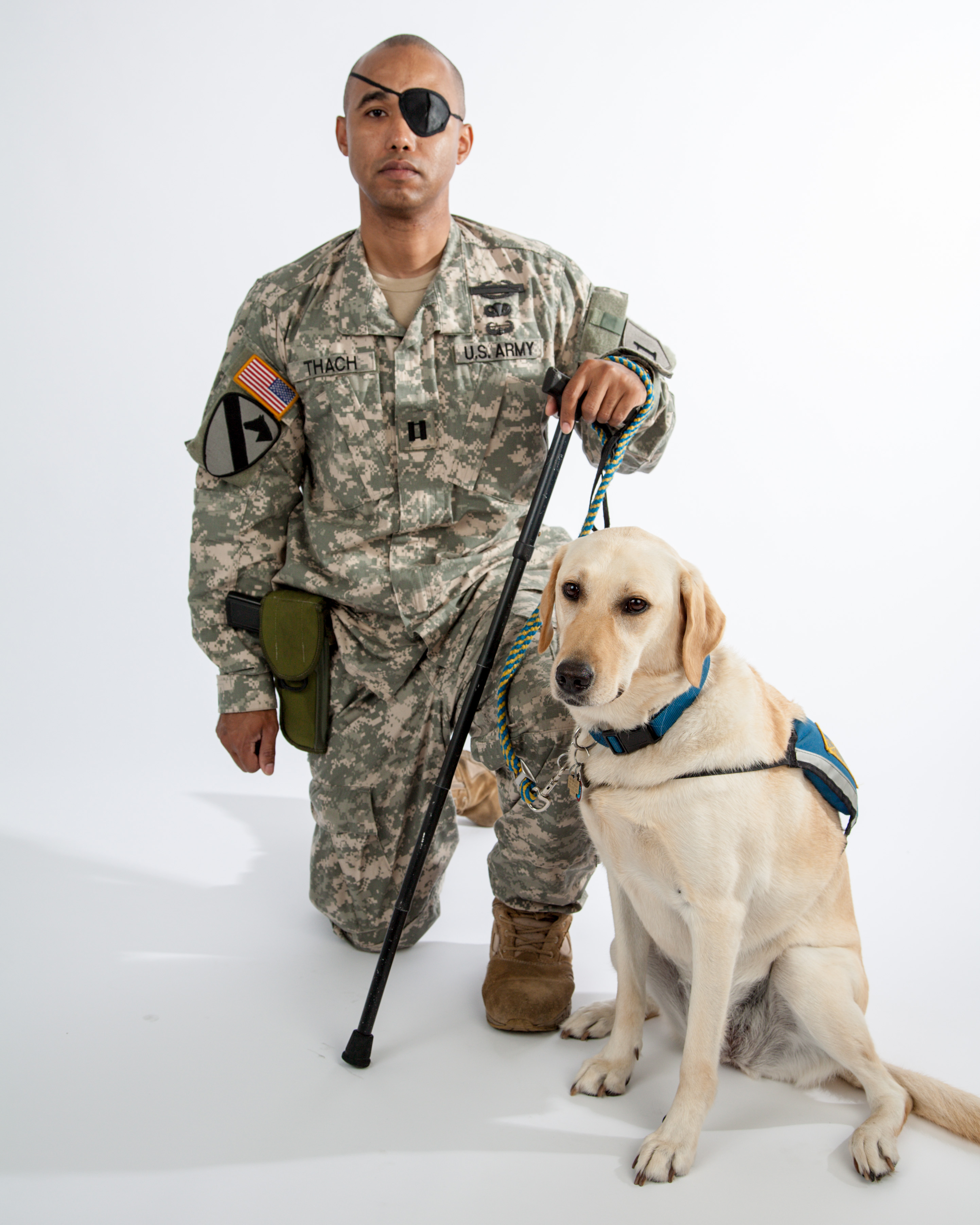 U.S. Army Captain James Văn Thạch with his service dog Liz. Photo credit: Photographer Leanne Vorrias