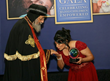 His Holiness Pope Tawadros II accepts the Leading by Example Award from Coptic Orphans founder and Executive Director Nermien Riad in Brampton, Canada, Sept. 28, 2014.