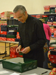 Fr. Kevin Baldwin, LC, Chaplain at Everst Academy in Lemont, wraps a gift box preparing for the Community Christmas Bash.