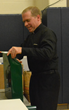 Fr. Jon Budke, LC, President of the Board of Directors at Everest Academy in Lemont, helps out and lends a hand with the wrapping.