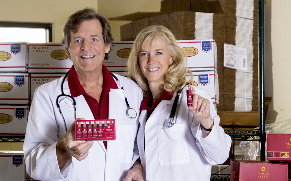 Dr. Bo Martinsen and Dr. Anne-Marie Chalmers holding the Omega Cure Extra Strength vials