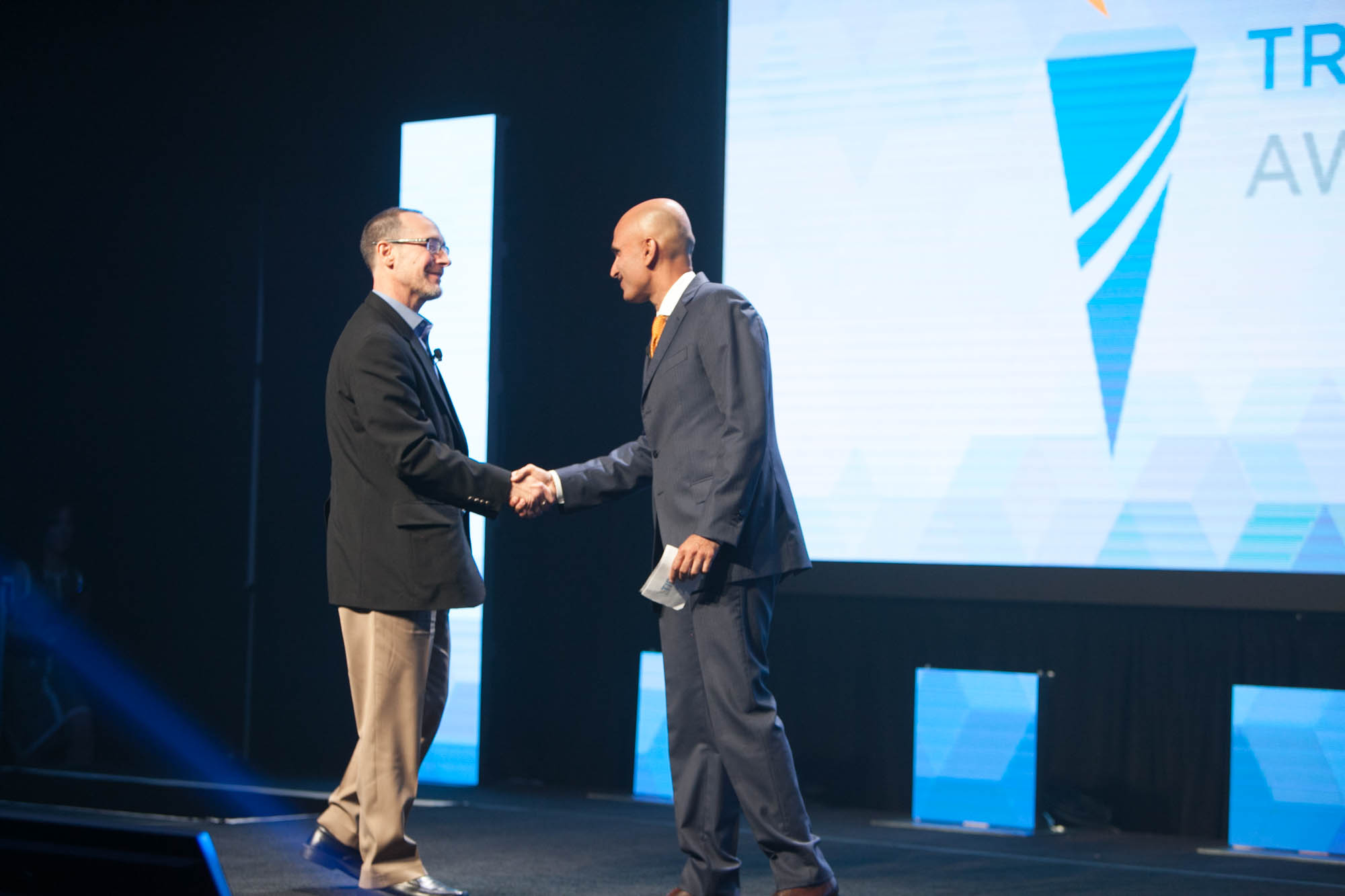 SofTrek president Robert Girardi accepts congratulations from TIBCO EVP Raj Varma on winning the TIBCO Trailblazer "Pioneer" Award