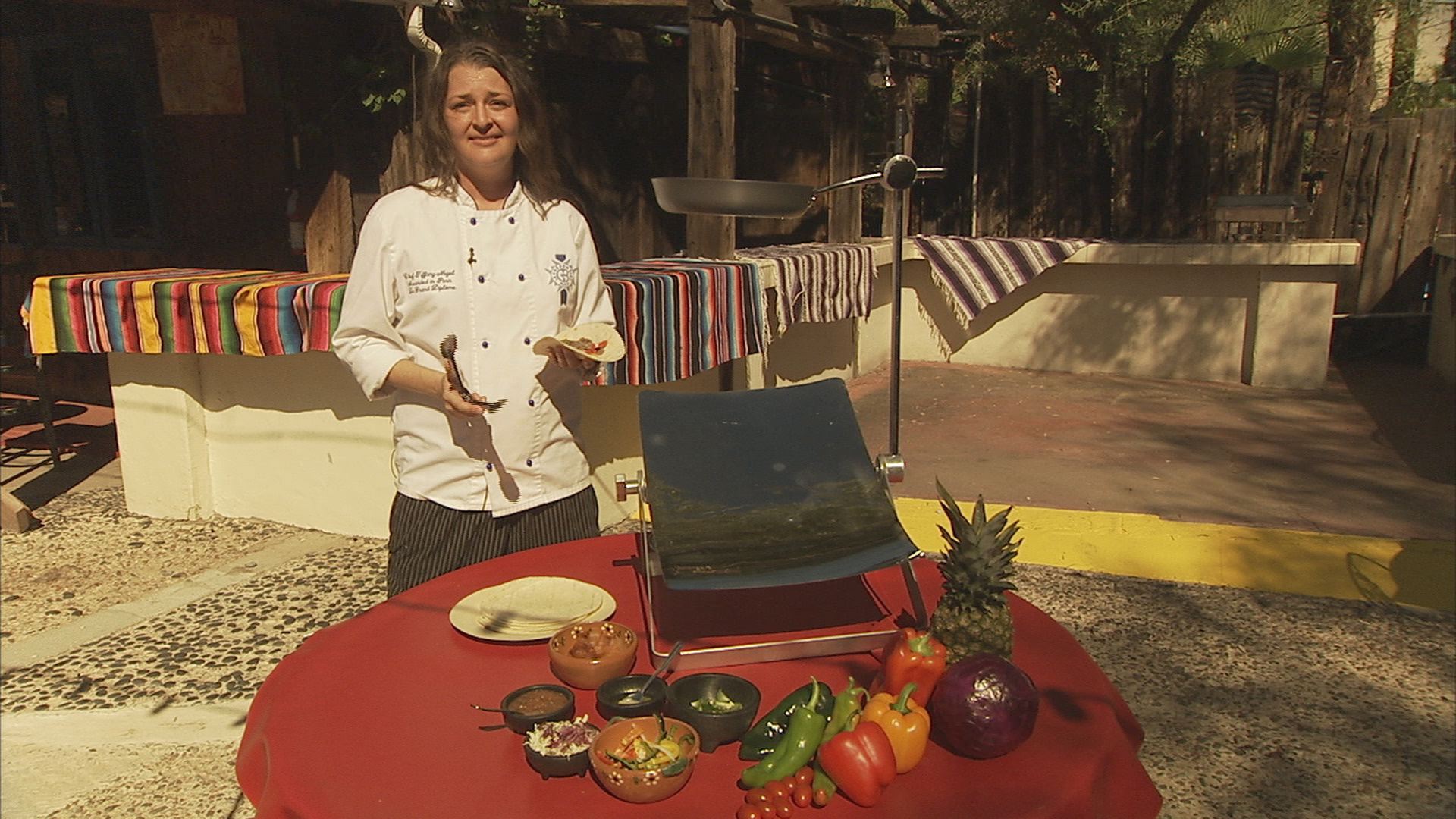 Chef Tiffany Allison of Aunt Chilada's in Phoenix, Ariz., shows off the Sol-Man Solar Cooker available on kickstarter.com.