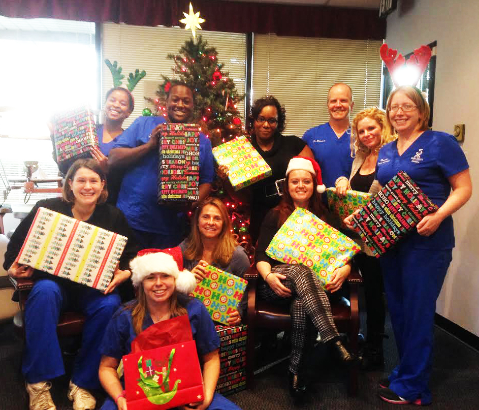 Smile Savers Dentistry staff with Christmas gifts for HopeWorks.
