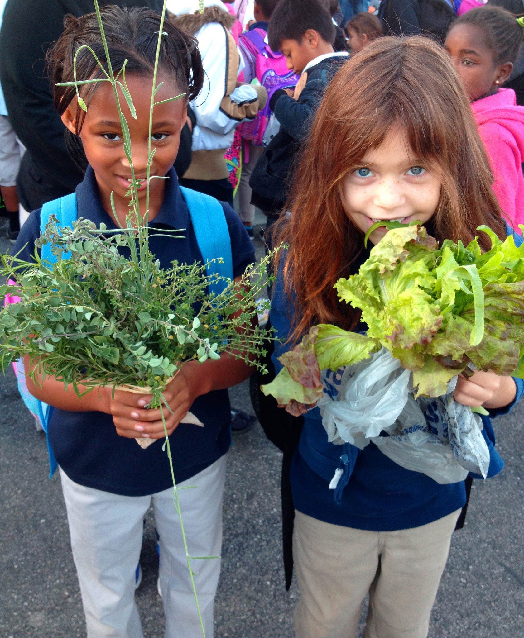 Two students with produce from their crowdfunded Outdoor Garden Classroom in Las Vegas, Nevada