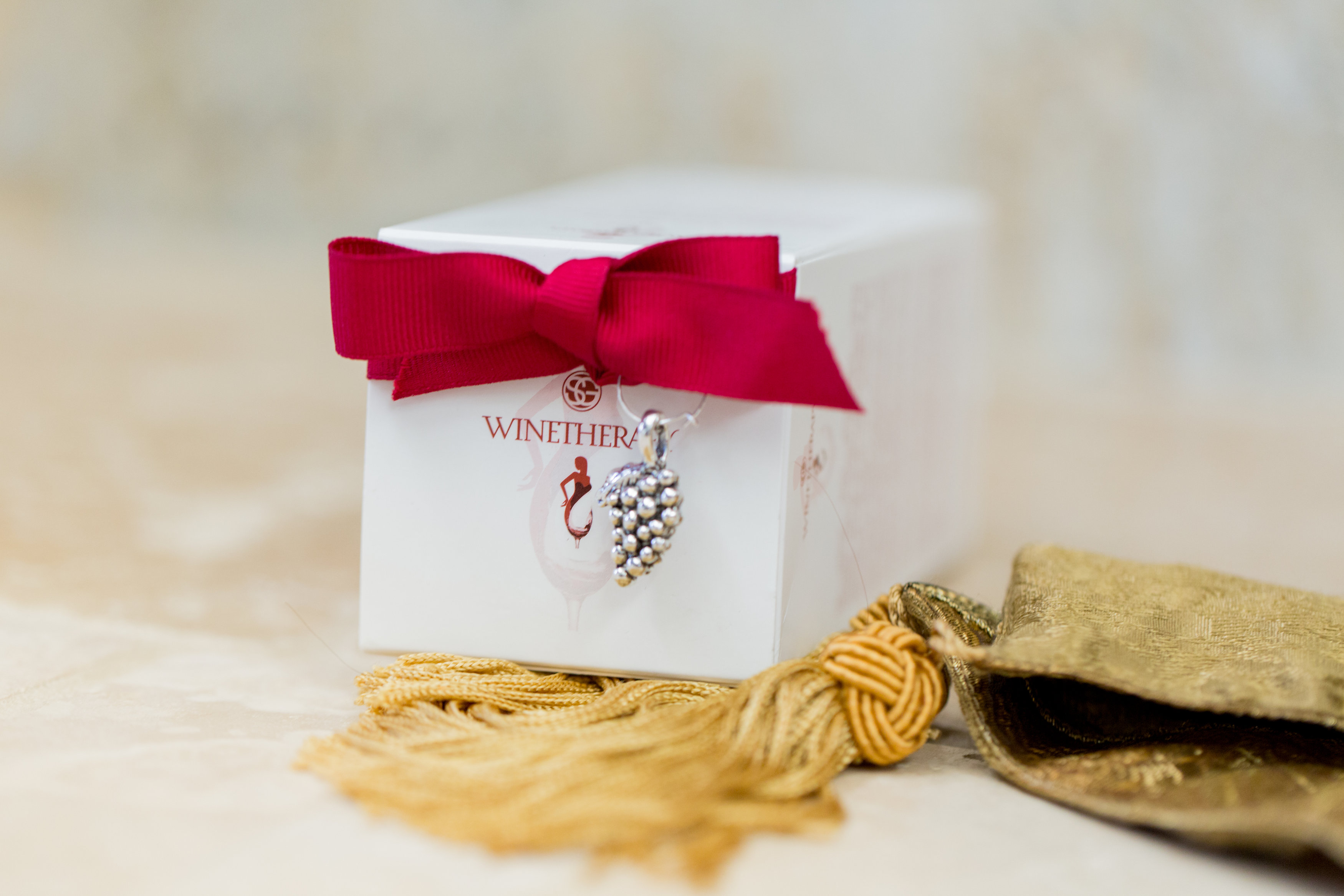Winetherapy products are packaged with a wine glass charm