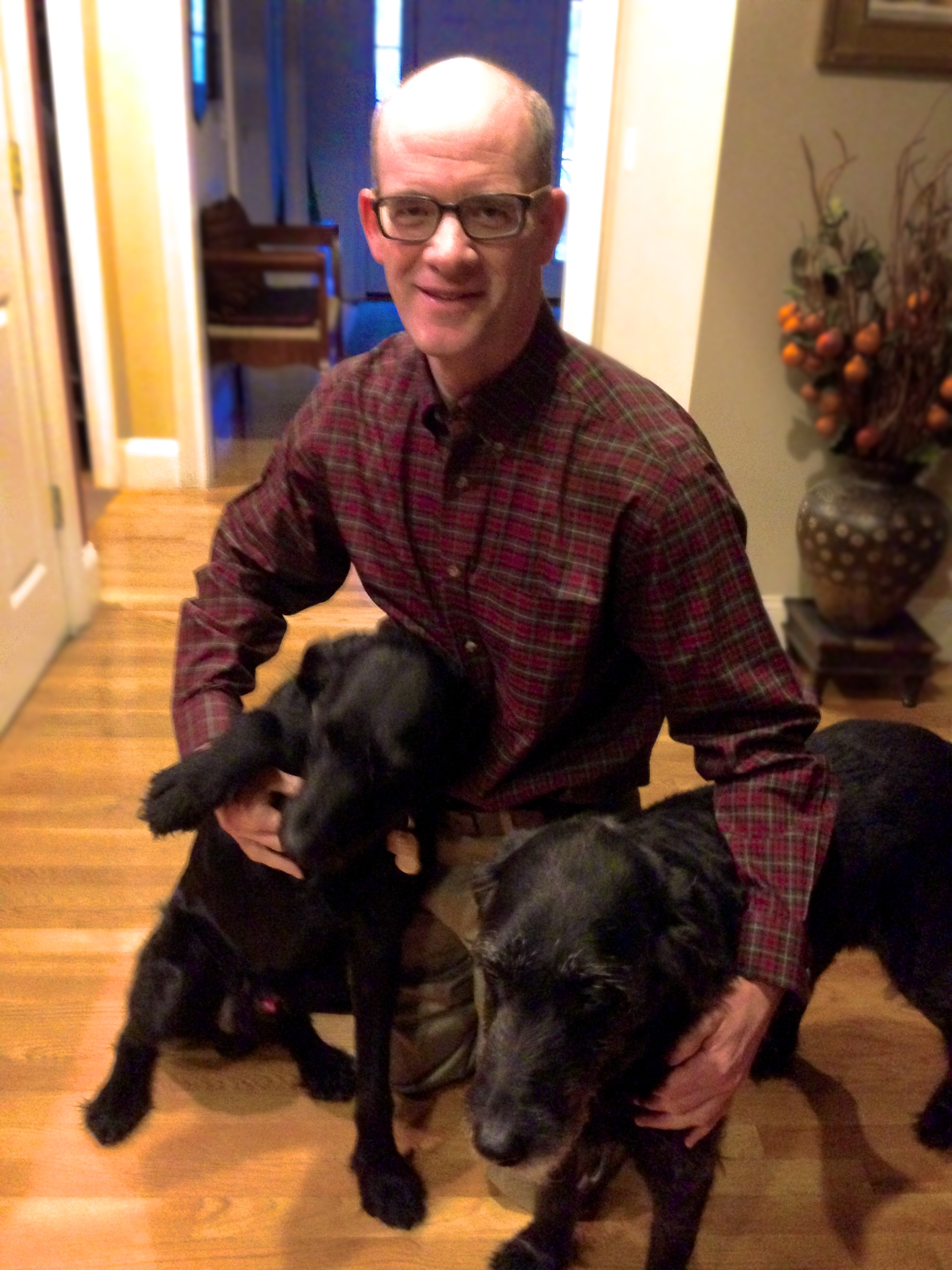 Mooney, who will use funding from the Michelson Grant to research a nonsurgical alternative to spaying and neutering dogs and cats, is pictured at home with his two dogs. Credit: Dave Mooney
