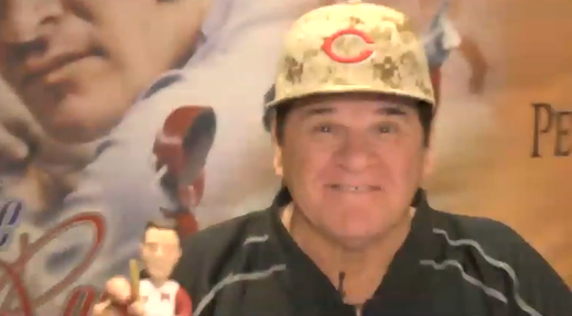 Pete Rose holding one of his bobbleheads