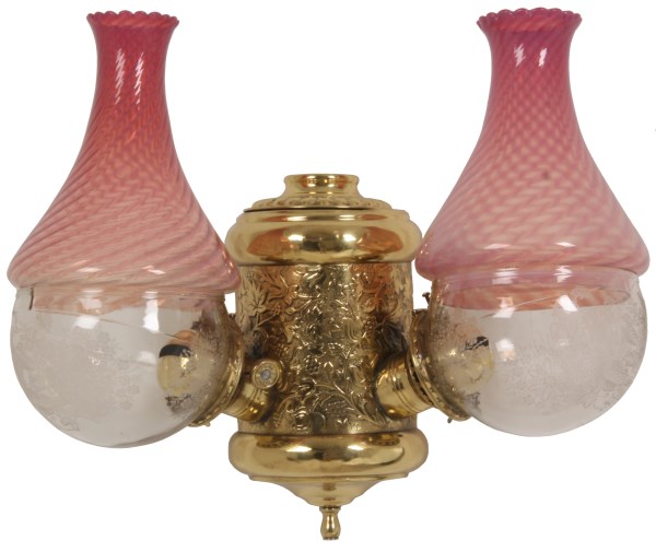 LOT 46 - Double Angle Lamp Wall Sconce. Polished gilt brass fixture signed "The Angle Lamp Co." with repousse filigree, rare cranberry opalescent swirl shades and floral etched globes, not electrified