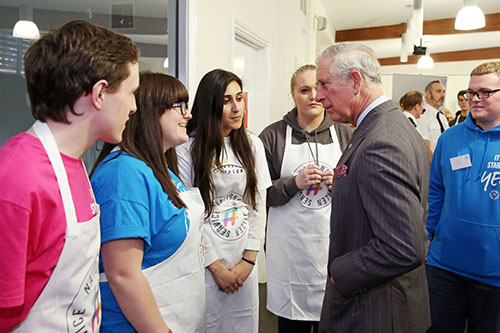 HRH Prince Charles Speaks To Volunteers From NCS In Their Printed Aprons