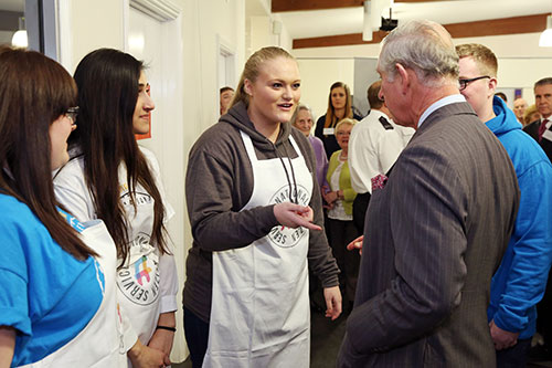 HRH Prince Charles Speaks To Volunteers From NCS In Their Printed Aprons