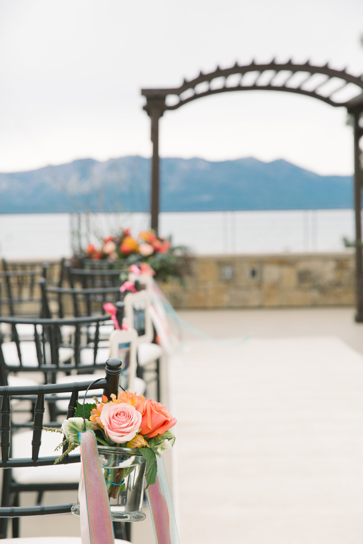 Details like fresh flowers on the aisle personalize The Landing’s luxurious lake-view Rooftop Terrace ceremonies (Photo by Lauren Lindley Photography).