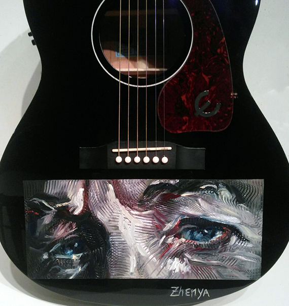 Artist Zhenya Gershman created a special portrait of Bob Dylan painted on a Caballero guitar that will be signed by Dylan and all performers at the tribute concert, then auctioned off at the benefit.