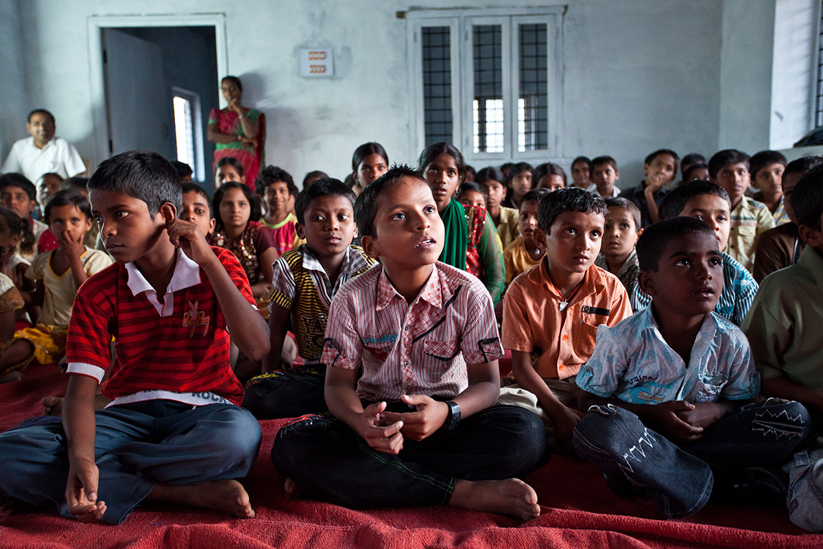 School children in India enjoying a lesson from their teacher.