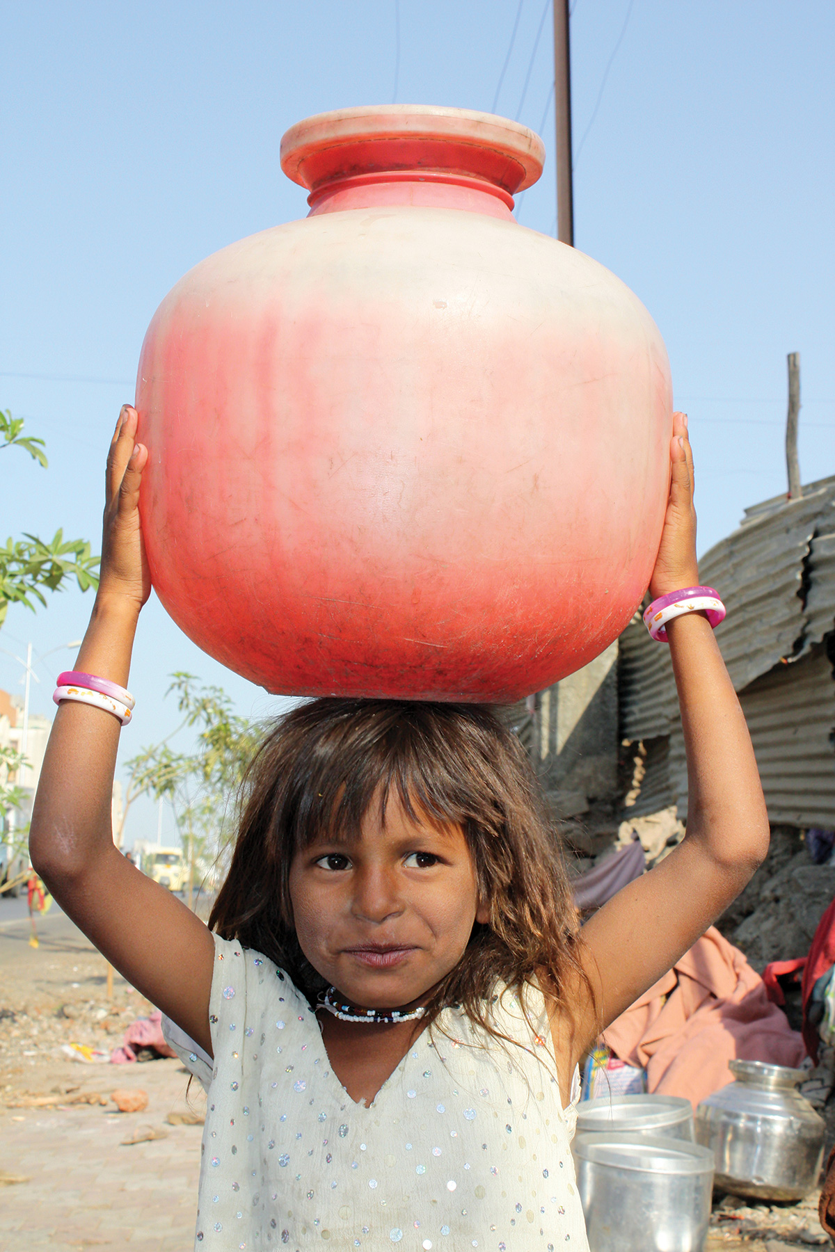 Girl in India carrying fresh water.