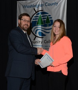 WCCC President Cassidy presents a scholarship to a student.