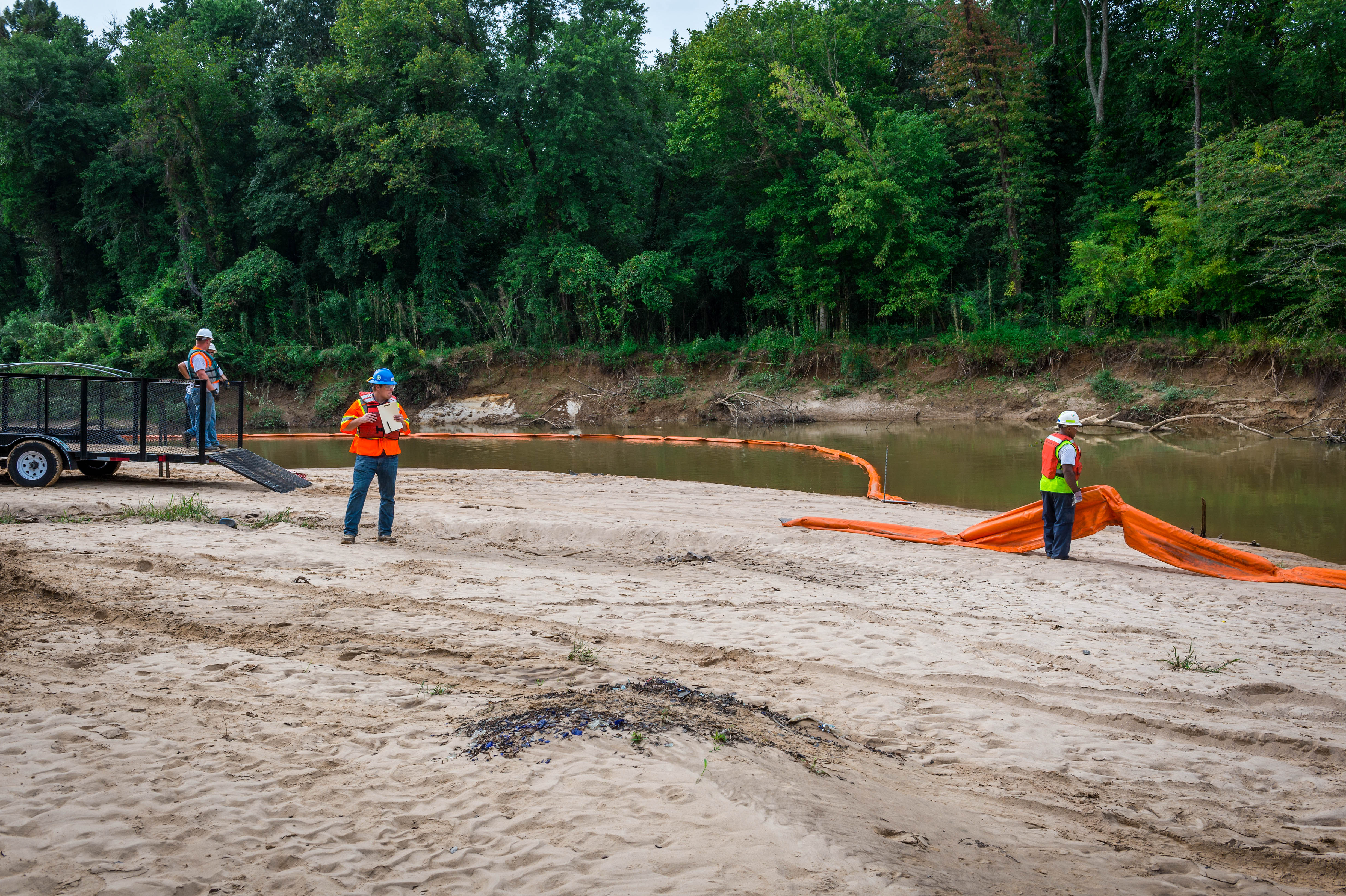 Maritime deployment response deploying absorbent boom for oil spill drills and training.