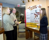 Hannah, an Everest Academy student, prepares for the Science Fair regional competition by discussing her winning project with Homer Township Vision Center
