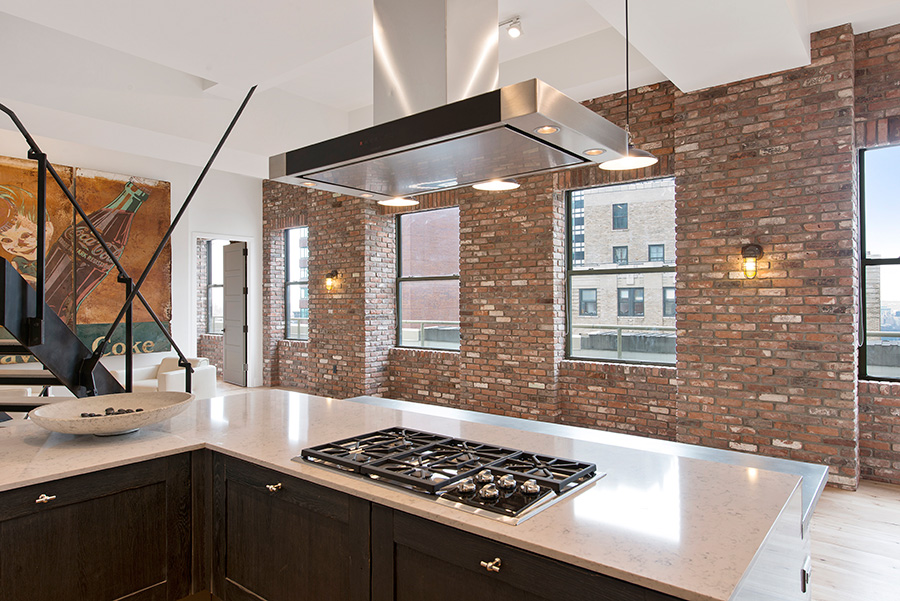 Reclaimed thin brick veneer and spacious windows offer a penthouse view of the Manhattan skyline.