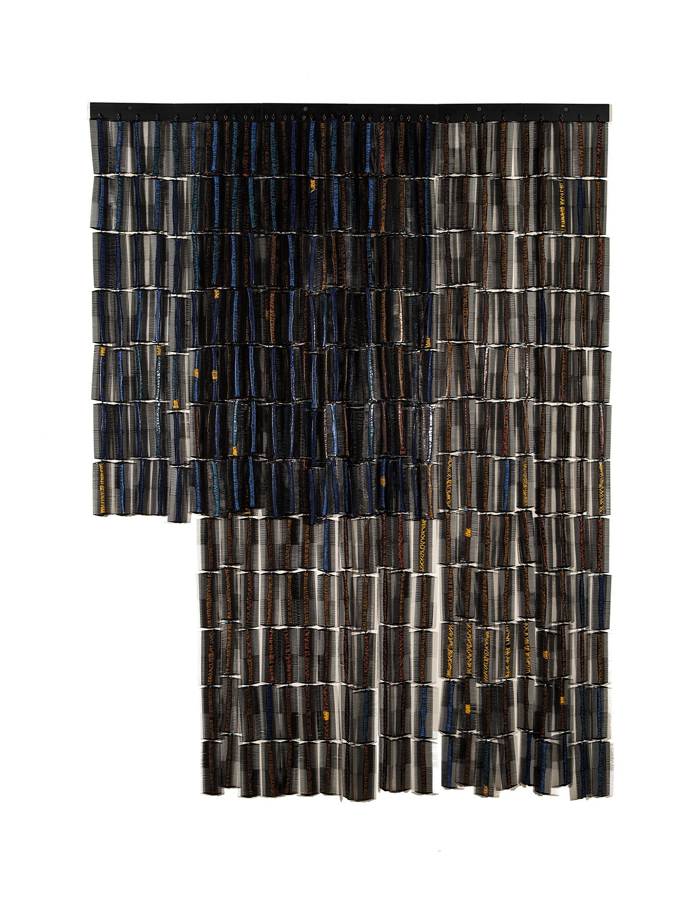 Sonya Clark, "Thread Wrapped in Blue and Brown," 2008. Combs, thread. Photo by Craig Smith, courtesy Arizona State University Art Museum.