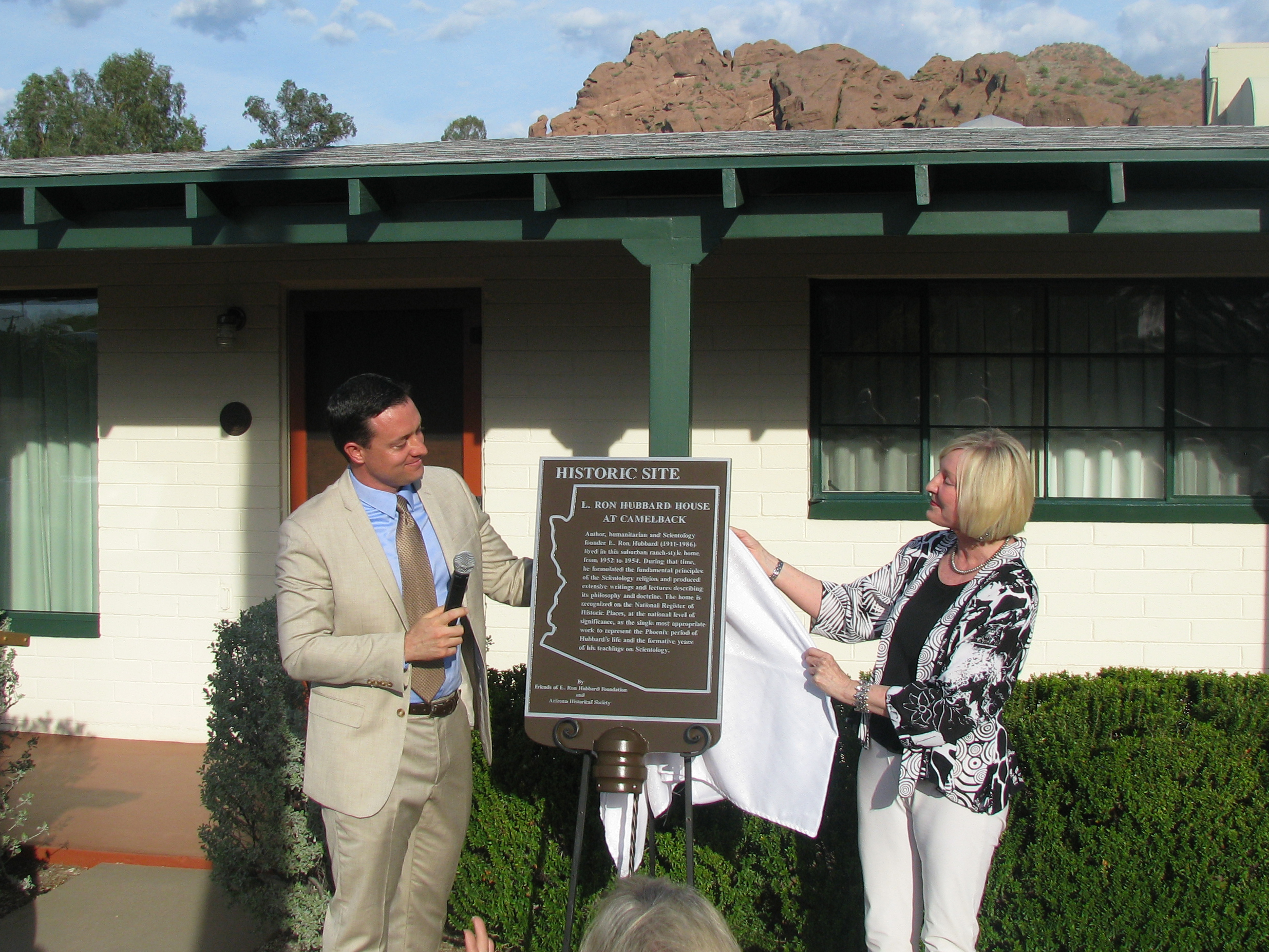 Historic Site Marker at L. Ron Hubbard House at Camelback is unveiled by Ben Davis, Friends of L. Ron Hubbard Foundation, and Dr. Anne Woosley, Executive Director of the Arizona Historical Society.