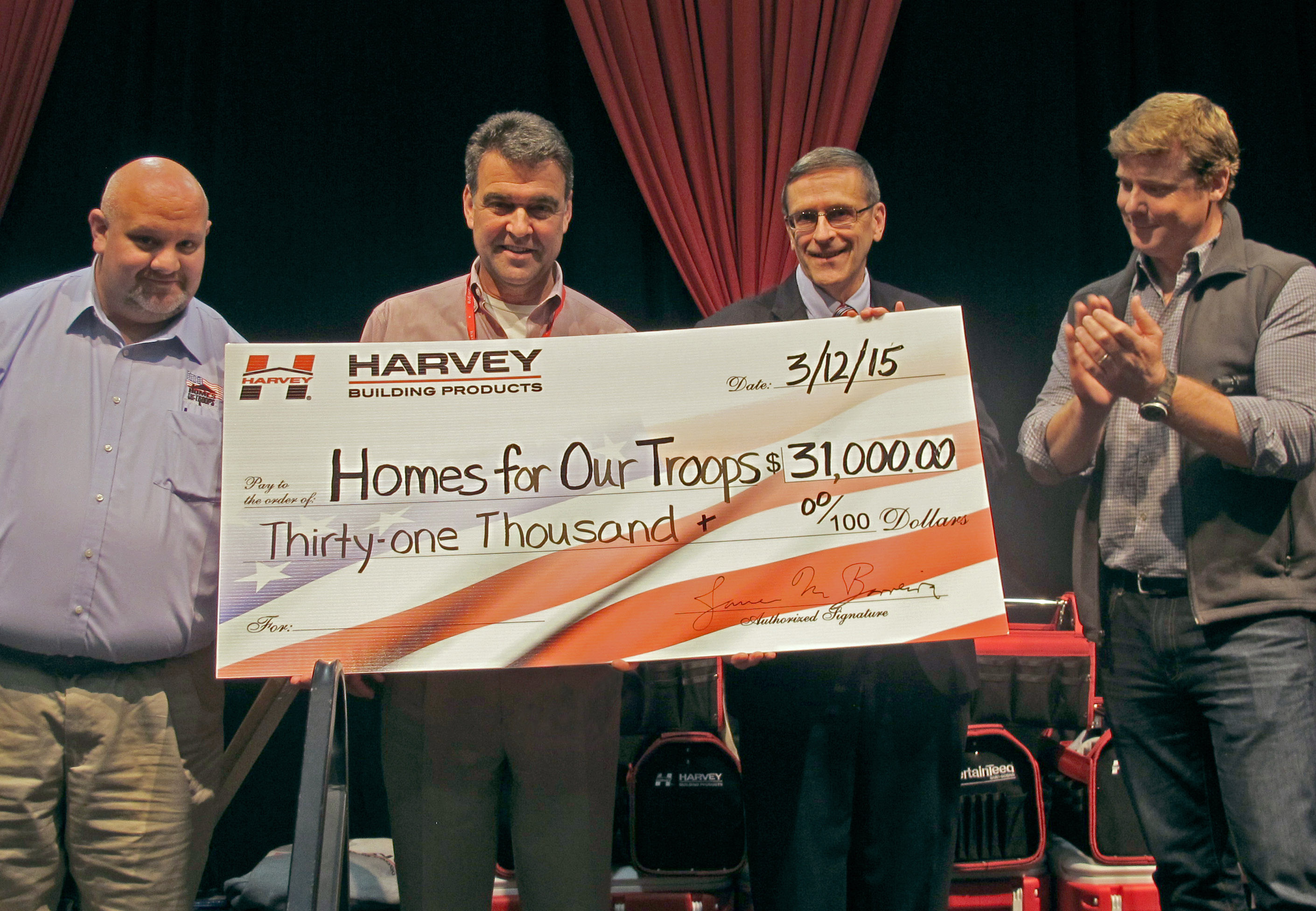 Harvey's president, Jim Barreira, presents $31,000 to Homes for Our Troops